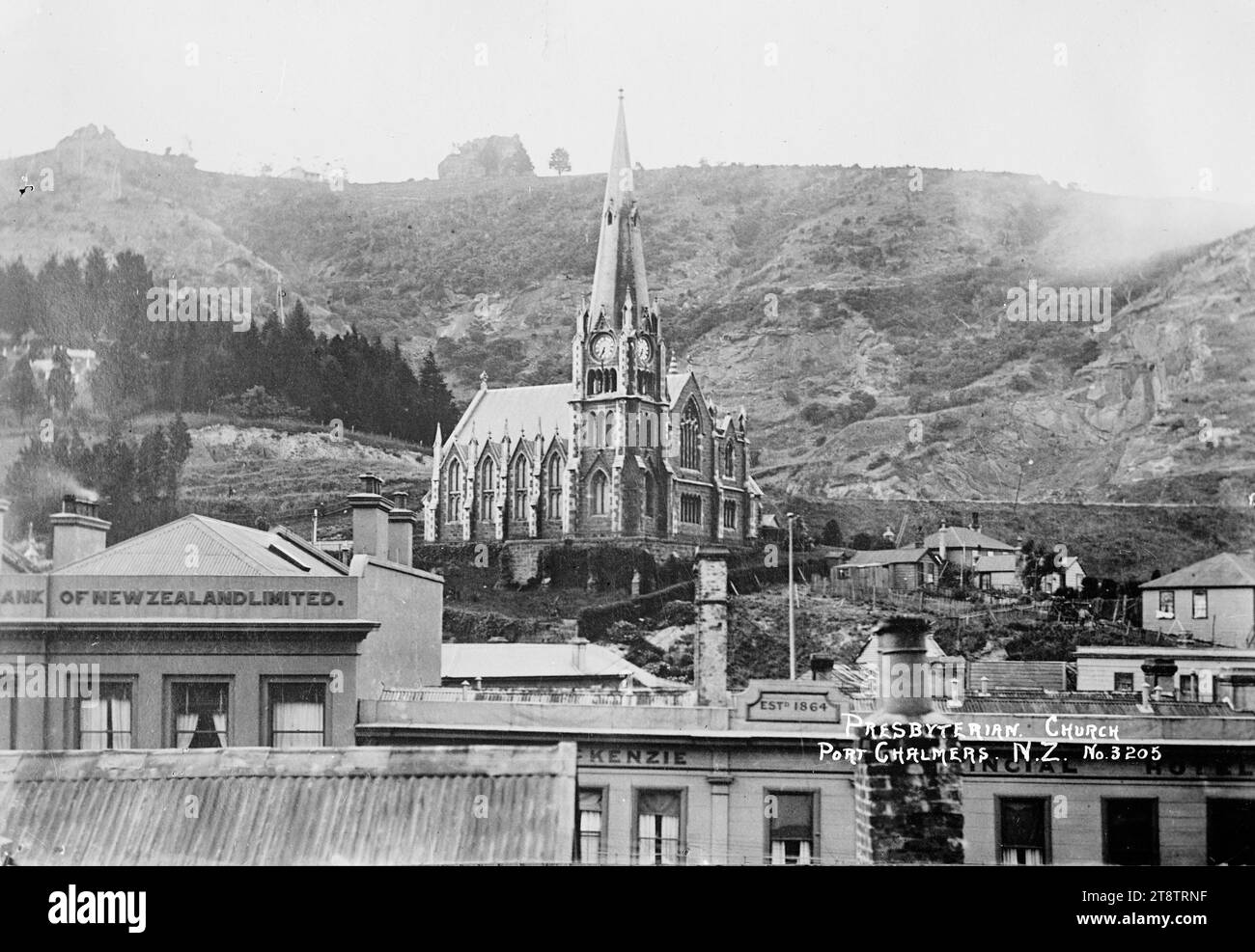Port Chalmers Presbyterian Church, View of the Presbyterian Church on the hill at Port Chalmers. The Bank of New Zealand building is in the foreground to the left. in the early 1900s Stock Photo