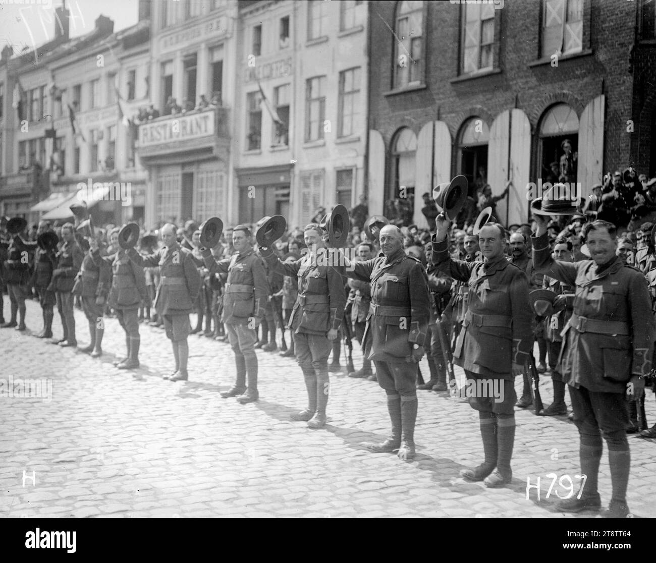 New Zealand army officers give three cheers for the King, New Zealand officers, standing in a line, take off their hats as they give three cheers for King George V at a military parade to celebrate victory at the Battle of Messines. The parade was held in the town square of Bailleul in France. Photograph taken 26 June 1917 Stock Photo