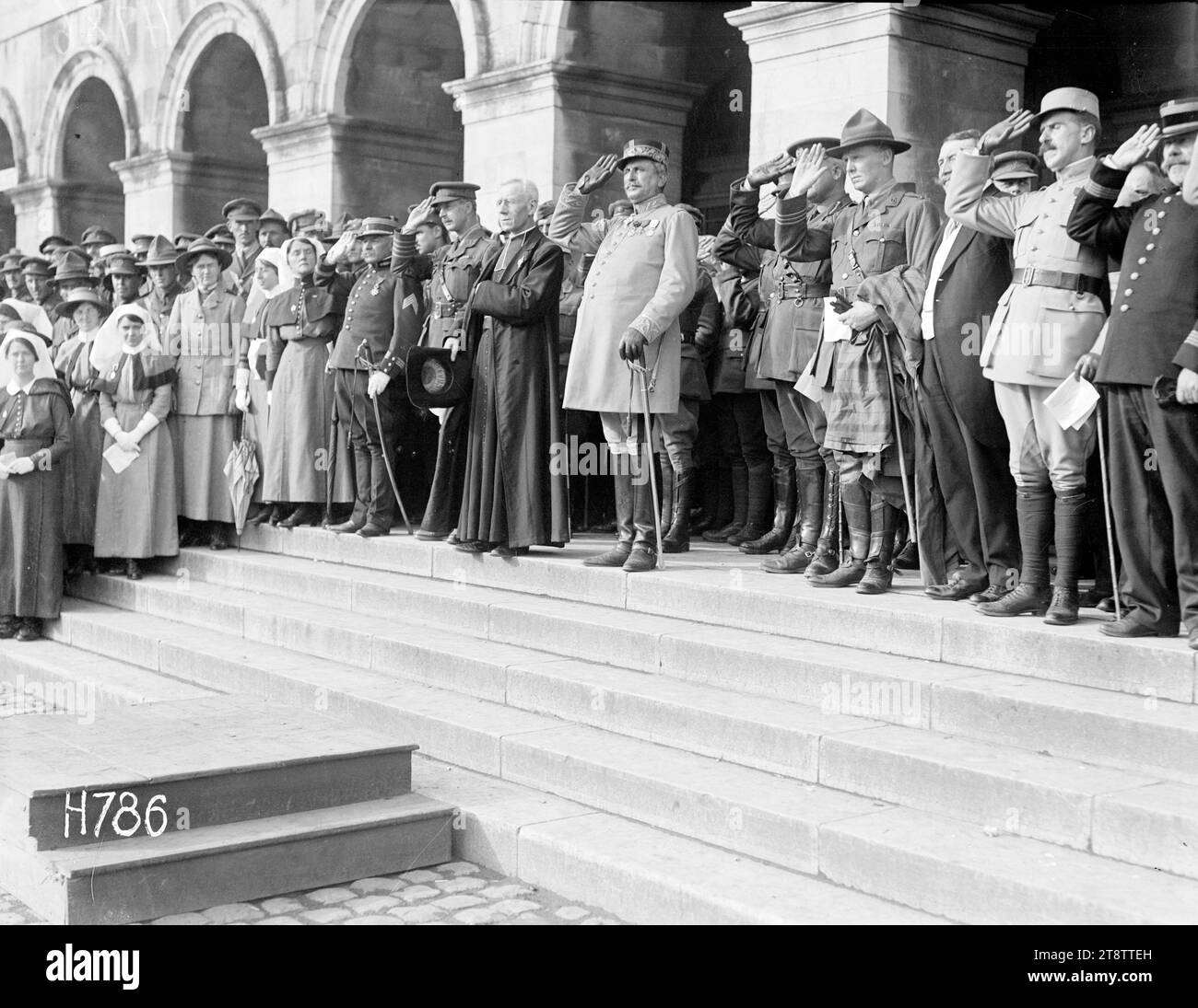 French, British and New Zealand officers taking the salute, Hazebrouck, French, British and New Zealand officers take the salute at the Fete National celebrations in Hazebrouck during World War I. To the left stand nurses from the New Zealand Stationary Hospital, including its matron Fanny Price (on right next to saluting officer). Photograph taken 14 July 1917 Stock Photo