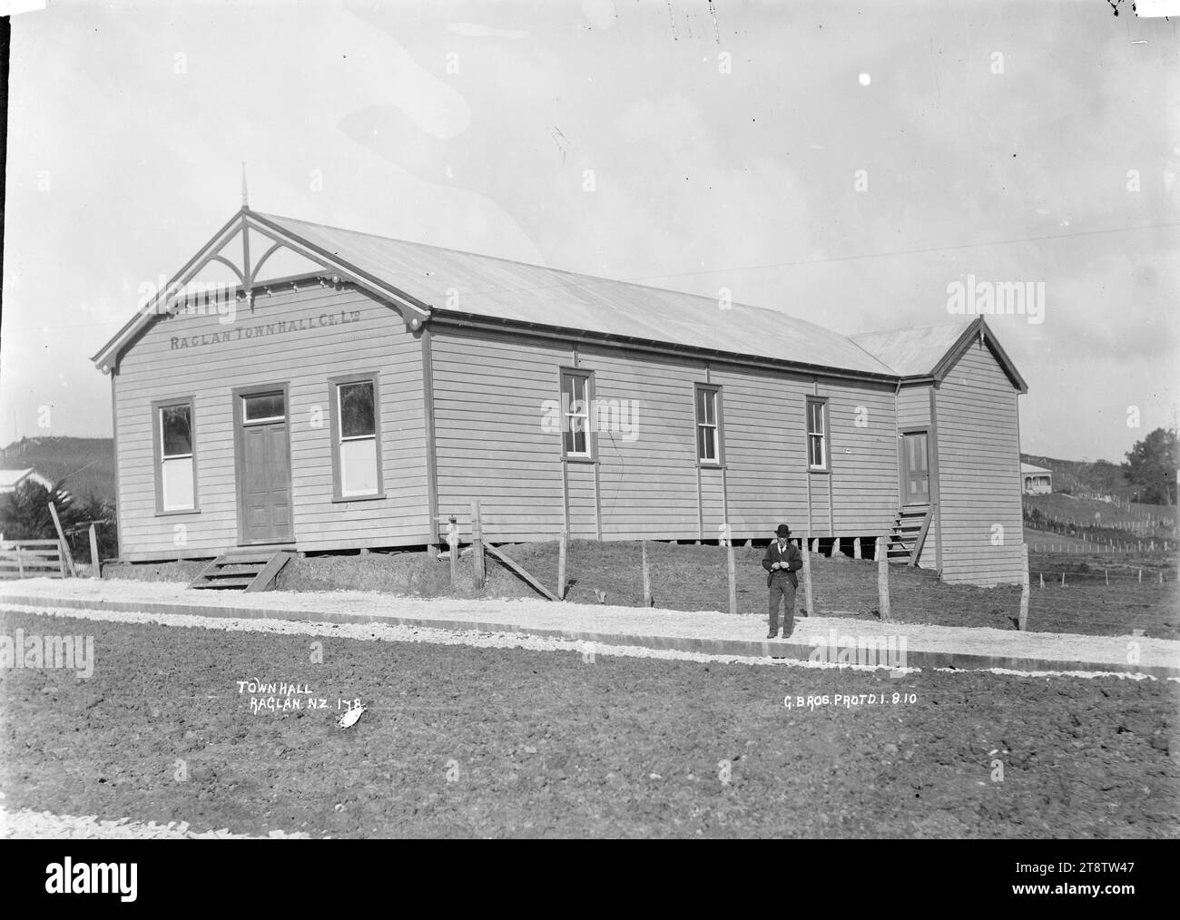 Raglan, New Zealand Town Hall, 1910, An unidentified man is standing outside the Raglan, New Zealand Town Hall, 1 August, 1910, photographed by Gilmour Brothers Stock Photo