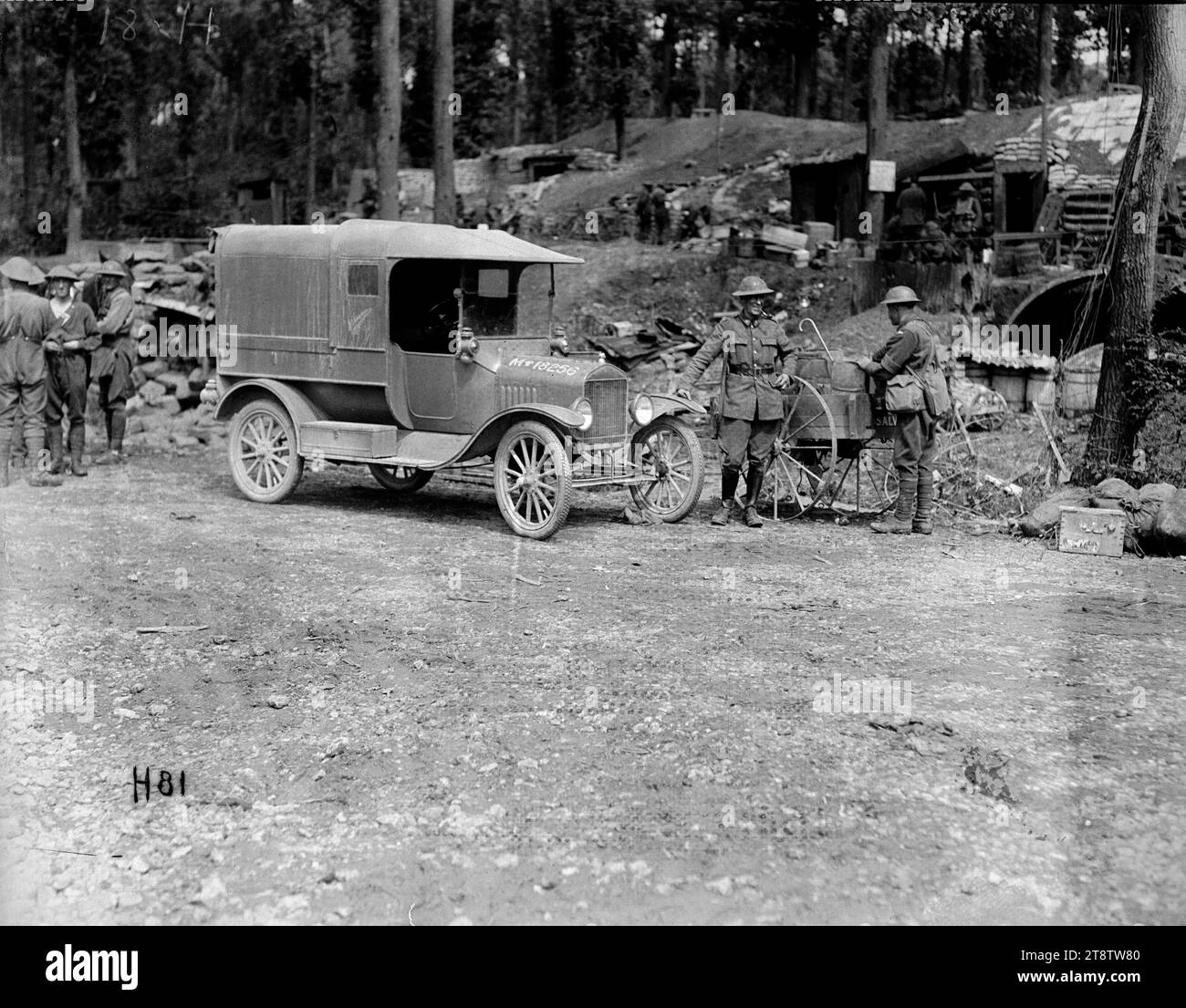 The official photographer's car in Ploegsteert Wood, World War I, The car used by the official New Zealand World War I photographer, Henry Sanders, parked at the heavily fortified New Zealand camp in Ploegsteert Wood, Belgium. The car has a fern leaf emblem on its side. In the background, the entrances to a number of dugouts can be seen. Photograph taken during World War I Stock Photo