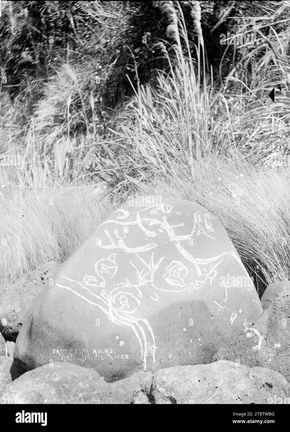 Tattooed rocks, near Raglan, New Zealand, 1911, Tattooed Rocks, near Raglan, New Zealand. This image shows the designs outlined in chalk for clarity. Taken January 1911 Stock Photo