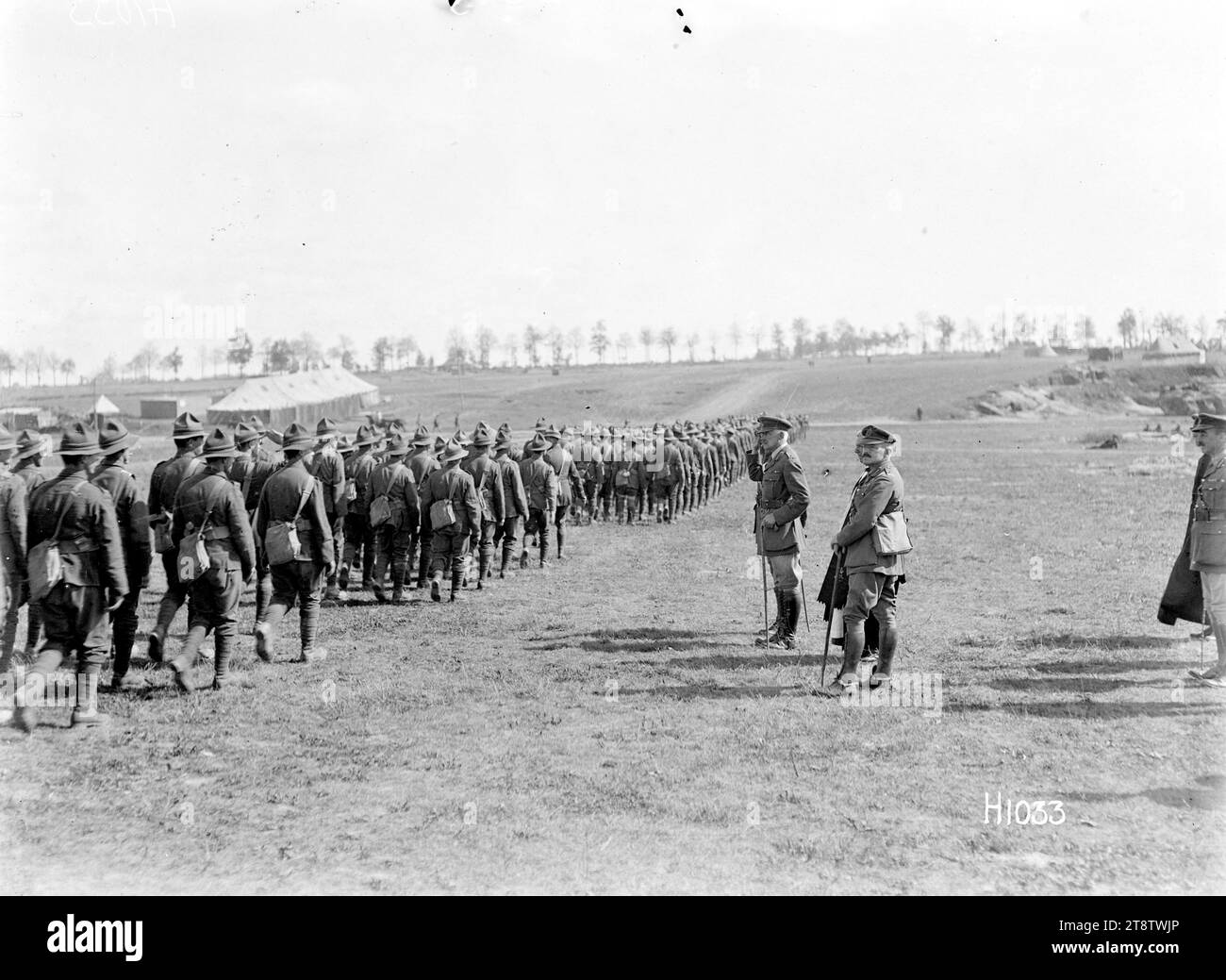 The salute after a New Zealand Brigade church service in France, World War I, The Corps Commander taking the salute after a New Zealand Brigade church service in Sapignies, France, during World War I. The Divisional Commander, General Russell, stands on his left. Soldiers file past down a slight slope. Photograph taken 8 September 1918 Stock Photo