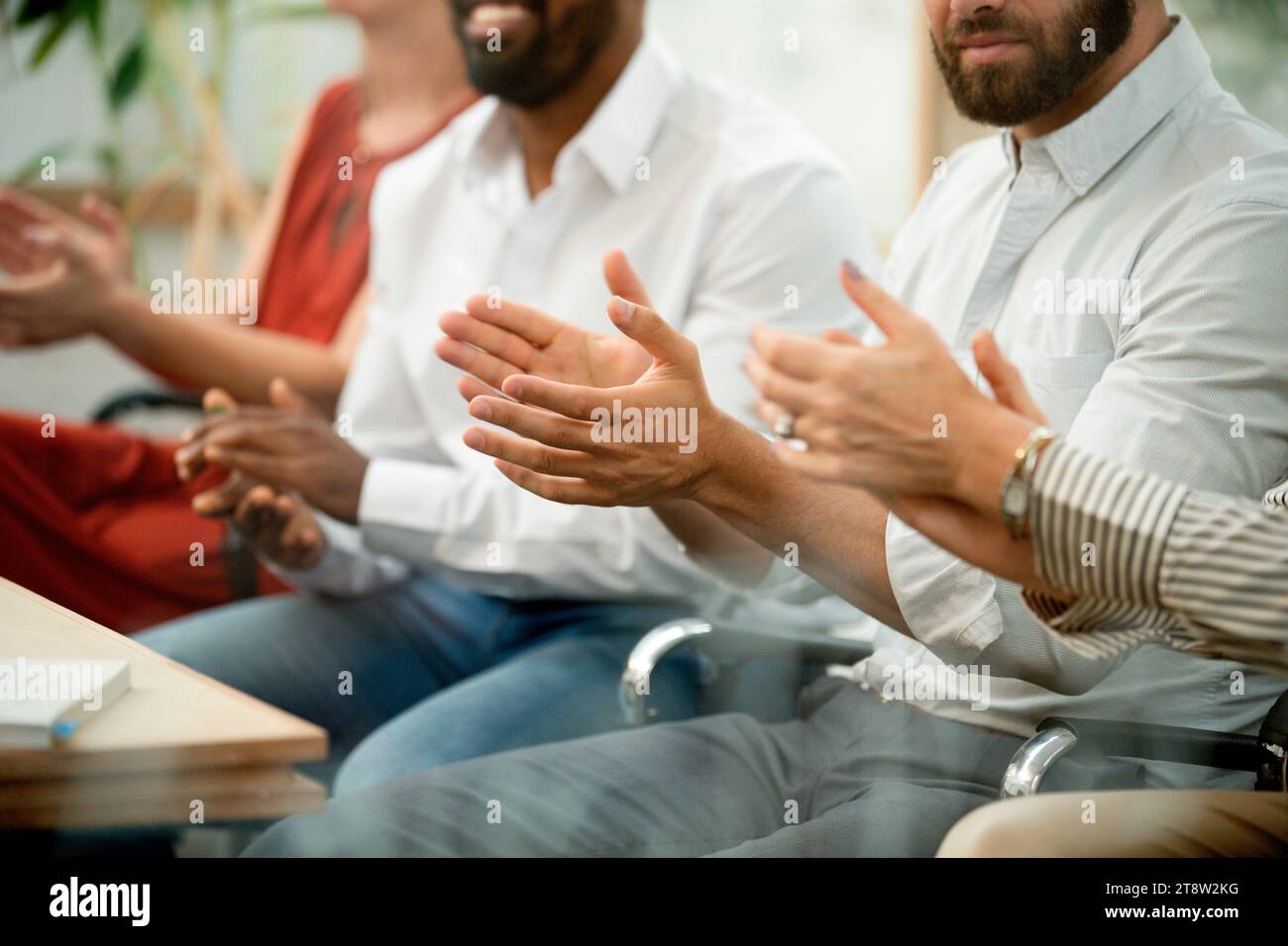 Mid section of business workers clapping hands after meeting Stock Photo