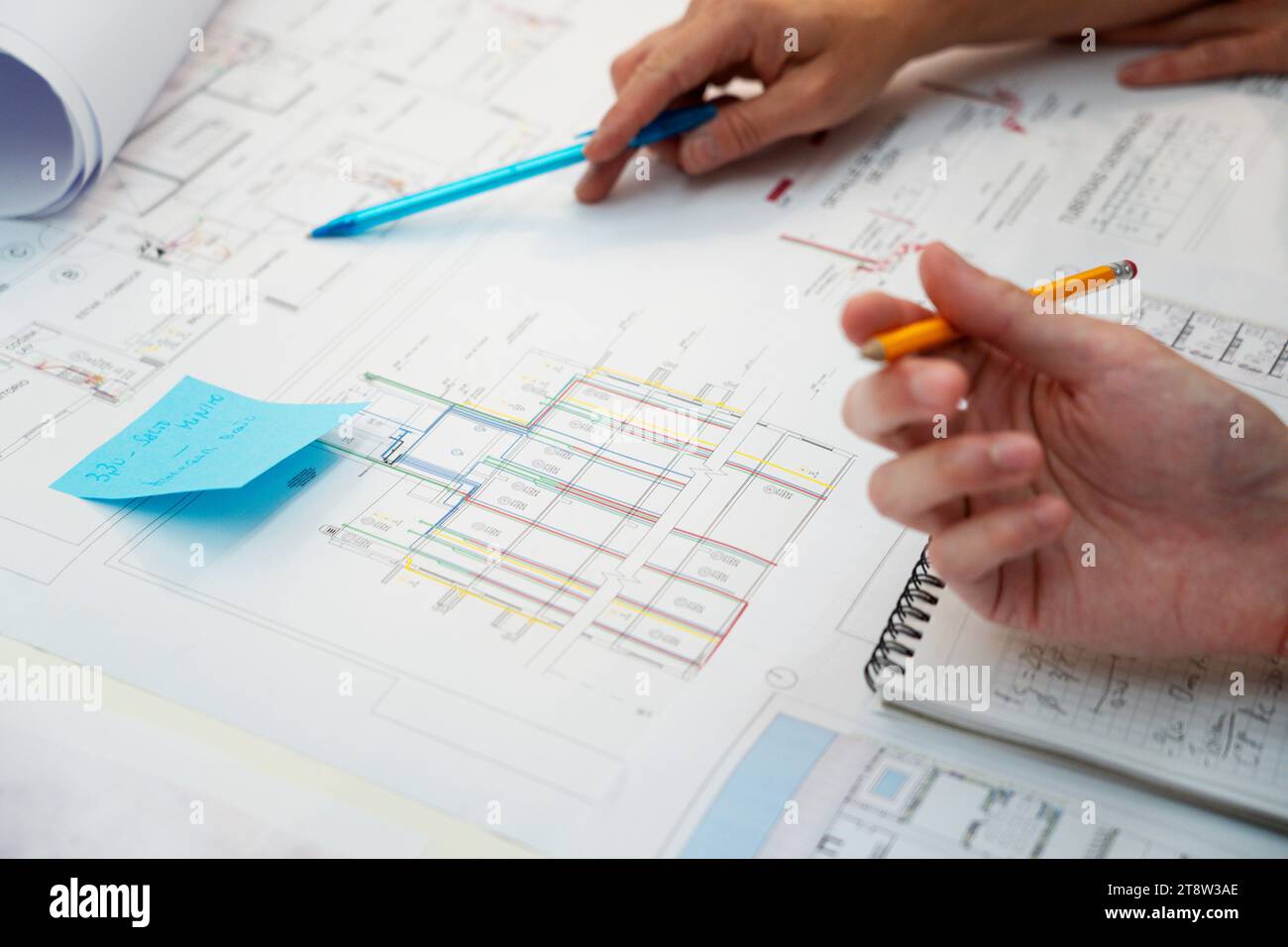 Cropped image of architects hands pointing on blueprint Stock Photo