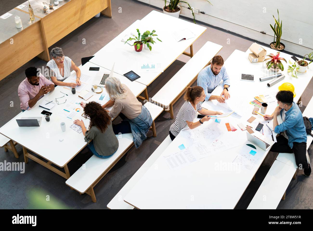 Wide view of place of work full of people having casual meetings Stock Photo
