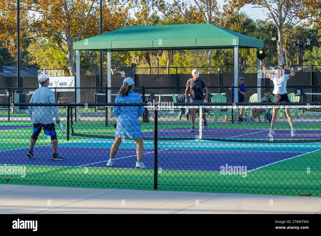Active senior couples playing pickleball at The Yards Pickle Garden at Sawgrass Players Club in Ponte Vedra Beach, Florida. (USA) Stock Photo
