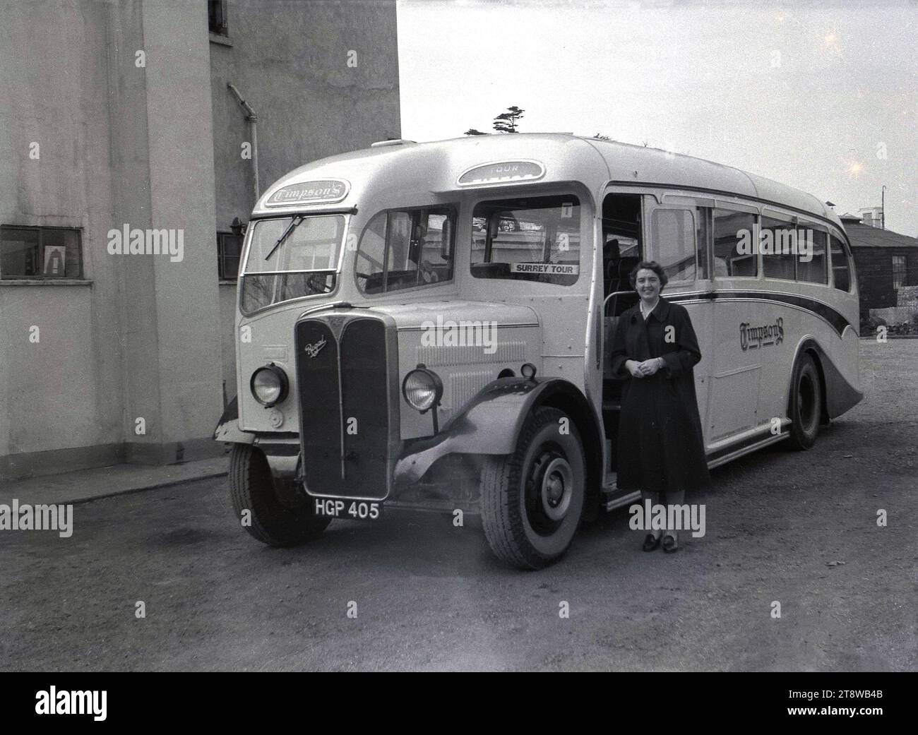 1950s, historical, a young woman standing by an Timpson's excursion motor coach, an AEC Regal, with a sign saying 'Surrey Tour', England, UK. A Timpson & Sons Ltd of Rushey Green, Catford, London, SE6, a business started in 1912 by Alexander Timpson, ran motor coach services to many of the popular south coast resorts in England in this era. Stock Photo