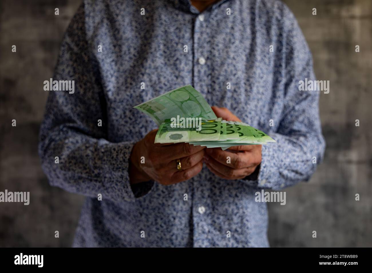 Bankruptcy spending money without limits debts taxes euro in the hands of a man Stock Photo