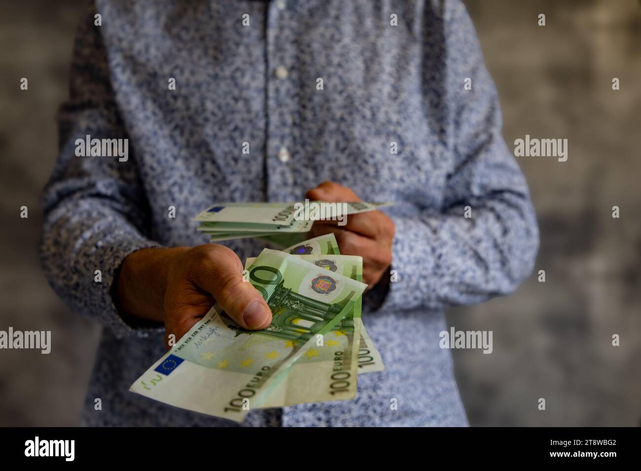 Bankruptcy spending money without limits debts taxes euro in the hands of a man Stock Photo