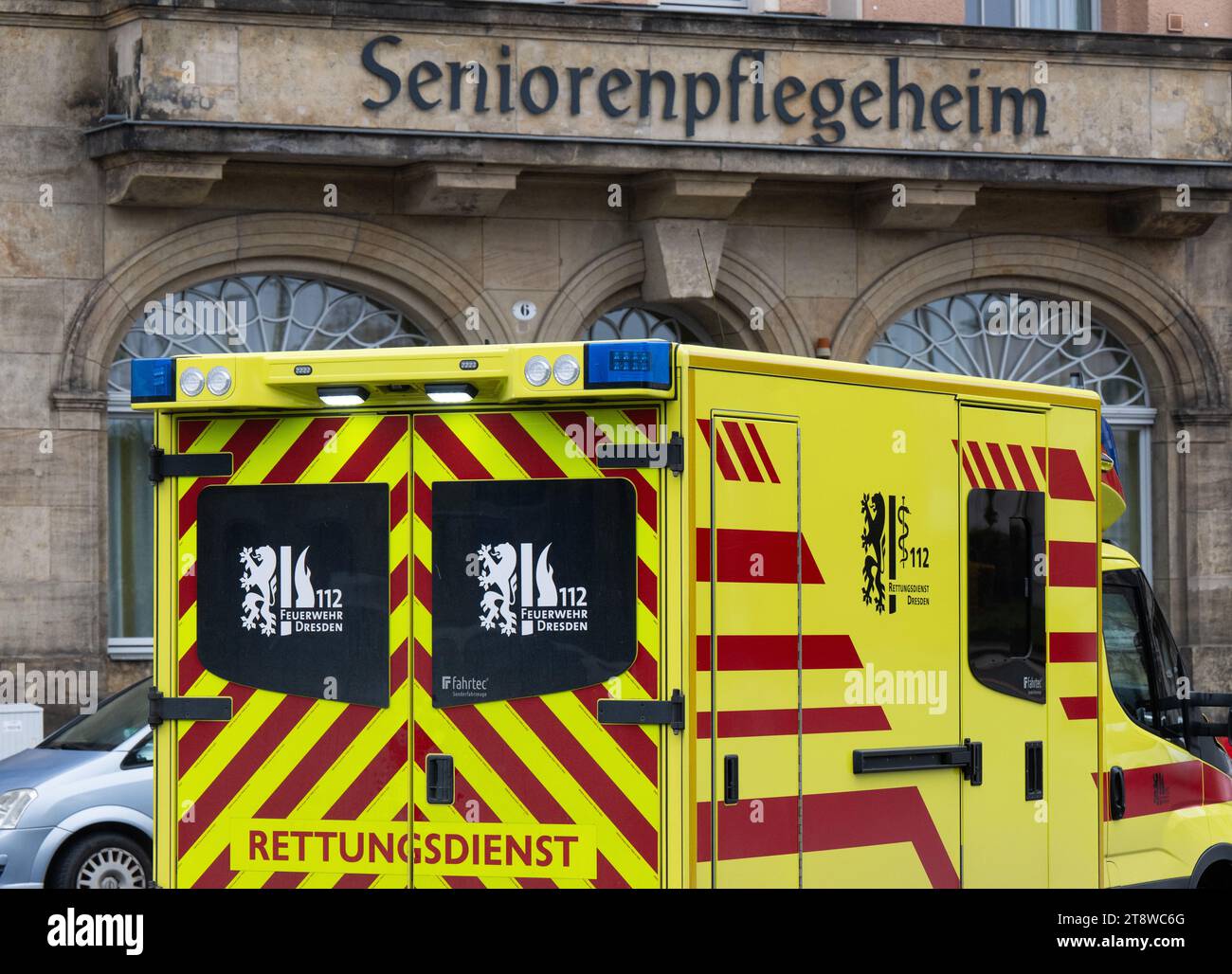 Dresden, Germany. 21st Nov, 2023. An ambulance from the Dresden fire department is parked in front of a retirement home at Neustadt station. Credit: Robert Michael/dpa/Alamy Live News Stock Photo