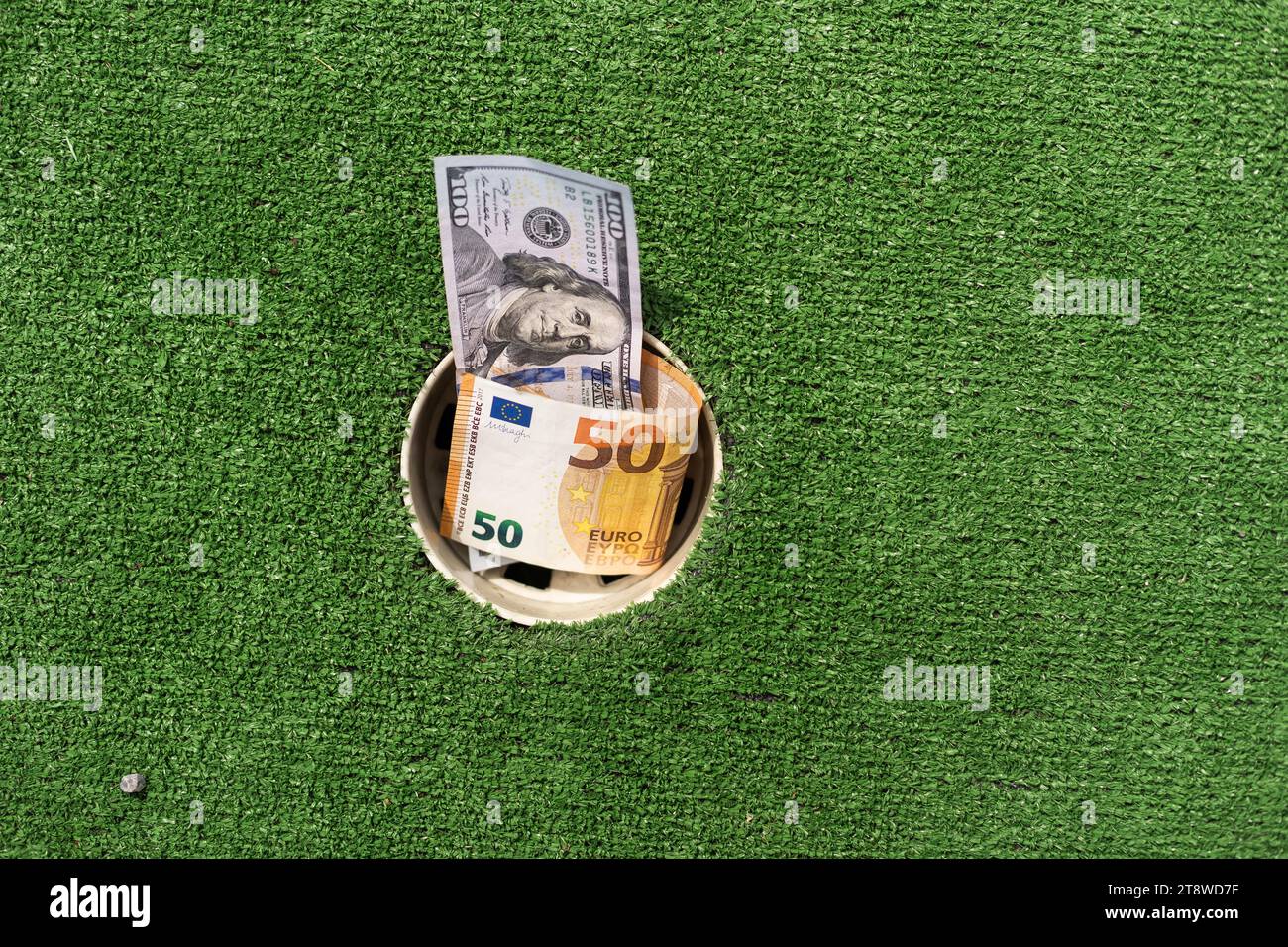 Mini Golf club, money on the artificial grass Stock Photo