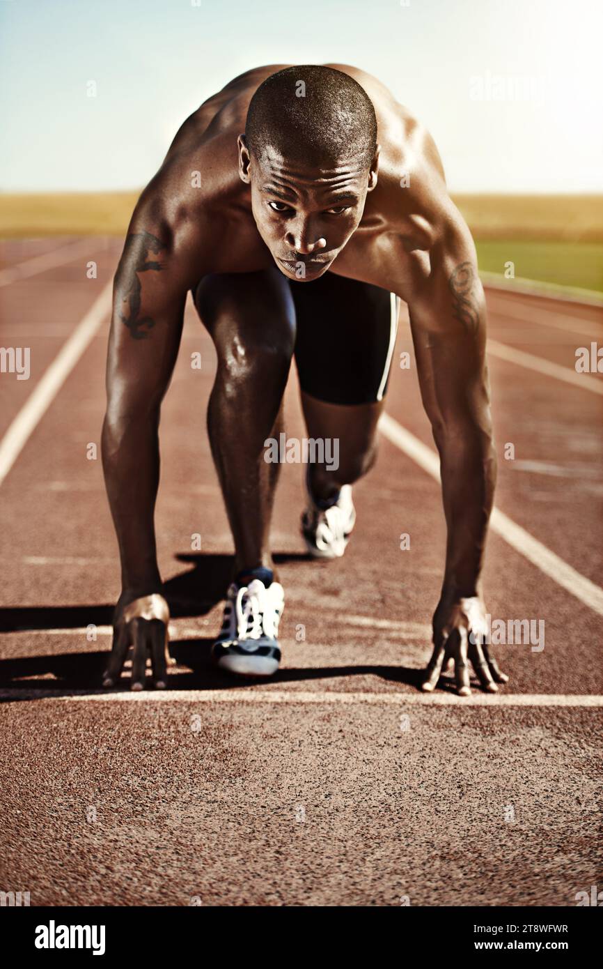 Portrait, man and ready for race, track and field with practice for competition. Olympics, male runner or athlete with determination on face for Stock Photo