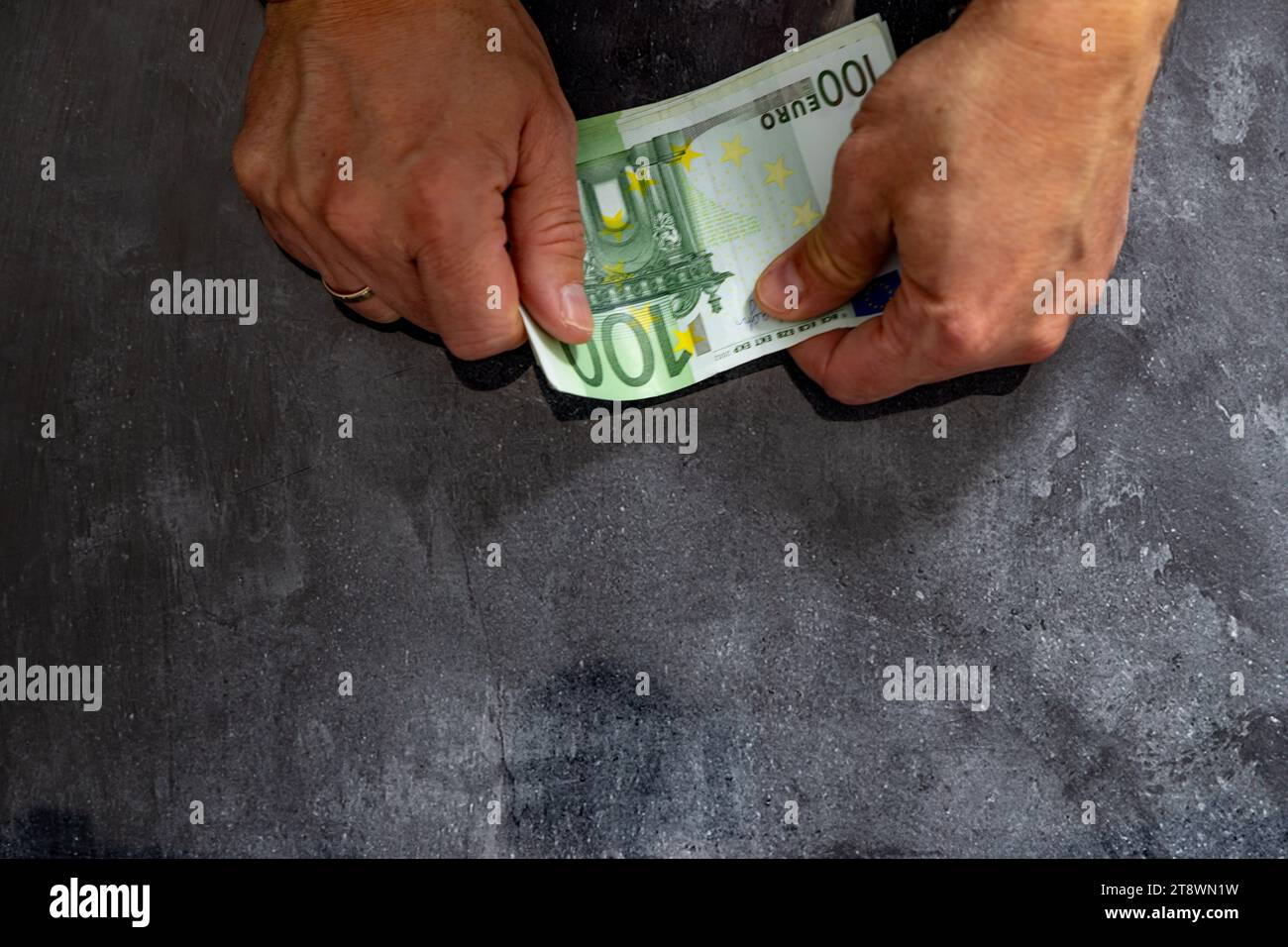 Bankruptcy spending money without limits debts taxes euro money in the hands of a man Stock Photo