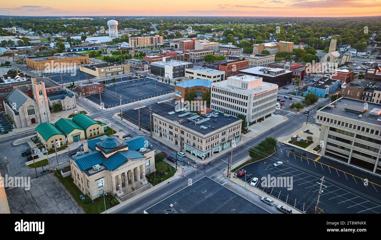 Office buildings in downtown Muncie, Indiana at sunset with pink sky in ...