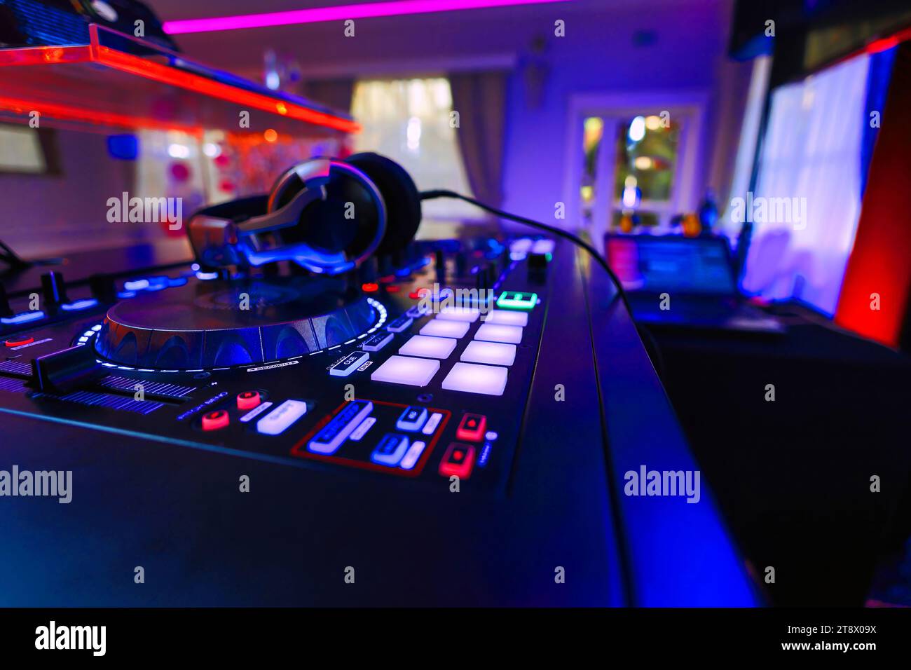 DJ table mixer closeup in the empty nightclub before the party. Stock Photo