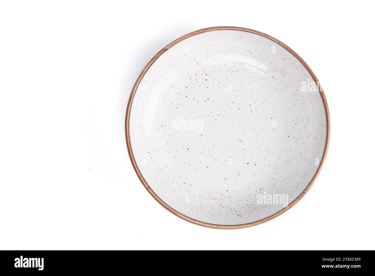 beige round ceramic plate with dotted isolated on a white background. top view. High quality photo Stock Photo