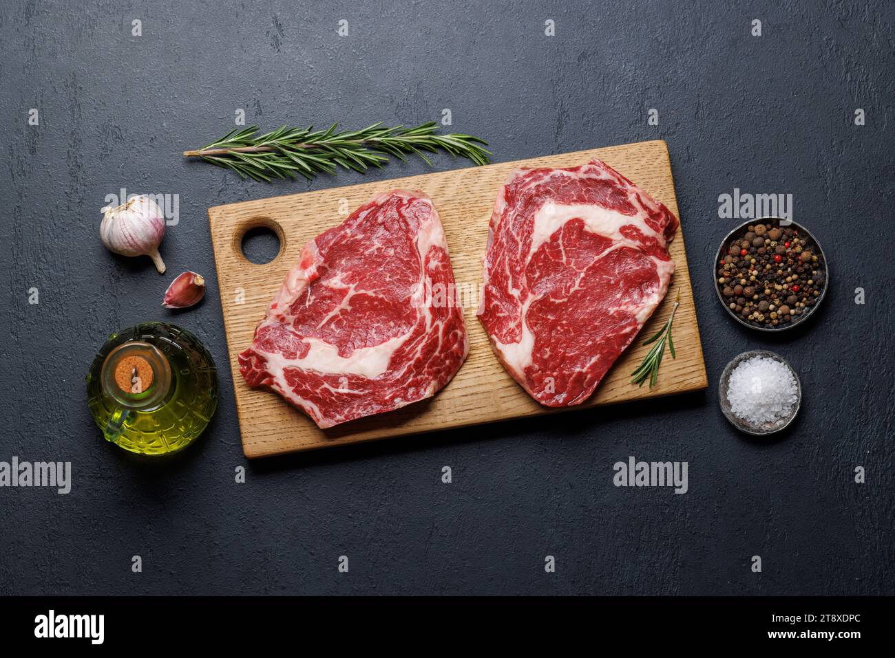 Raw ribeye steaks with savory spices. Flat lay Stock Photo Alamy
