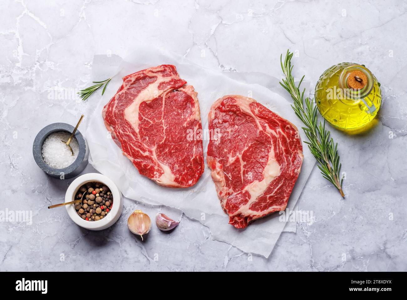 Raw ribeye steaks with savory spices. Flat lay Stock Photo Alamy