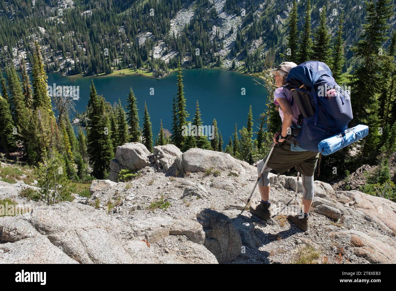 OR02676-00....OREGON - Woman backpacking above Steamboat Lake on the North Minam Trail #1675 in the Eagle Cap Wilderness, Wallowa-Whitman National Fo Stock Photo