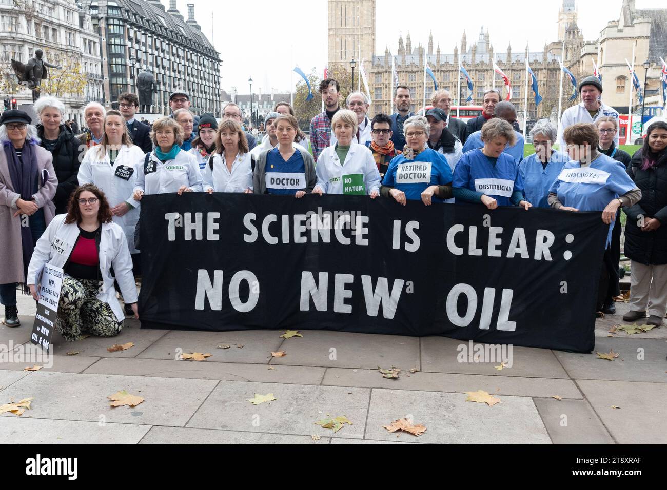 London, UK. 21 November, 2023. Scientists, health professionals, educators and campaigning organisations from the No New Oil Coalition gather in Parliament Square before going to the House of Commons to visit their MPs to lobby for greater action combating climate change. The group hope to gain support among Parliamentarians to oppose the granting of new licences for oil and gas extraction which, climate scientists say, is incompatible with meeting Paris Agreement cuts in CO2 emissions. Credit: Ron Fassbender/Alamy Live News Stock Photo