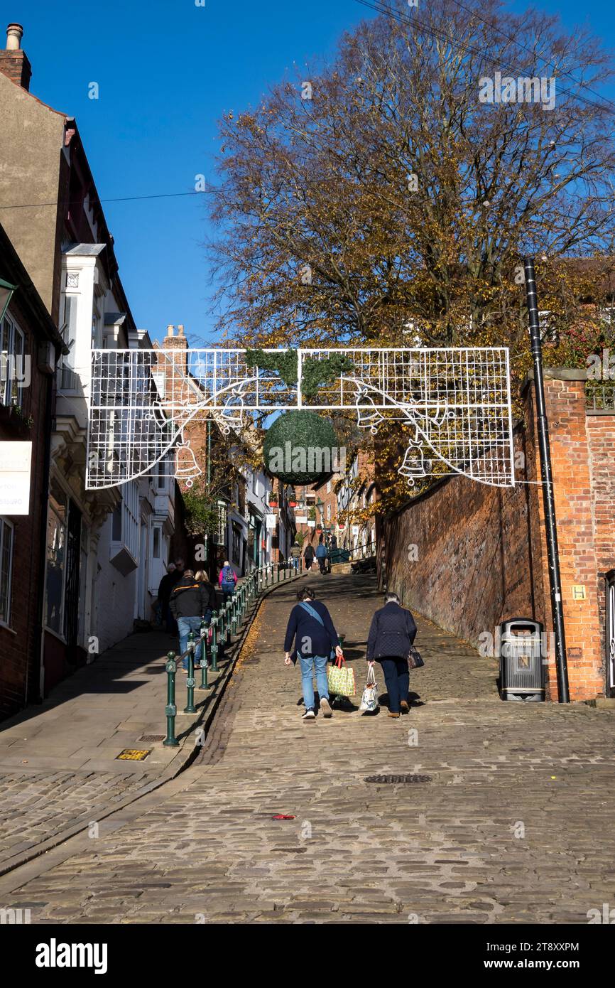 Christmas decorations going up at bottom of Steep Hill, Lincoln City, Lincolnshire, England, UK