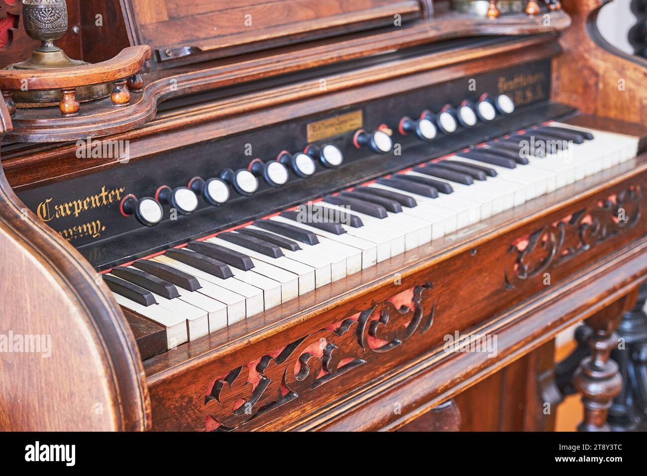 Yelabuga, Russia - June 18, 2023: Close-up of vintage musical keyboard instrument - harmonium, 19th century. Upper manual keyboard and pitch registers Stock Photo