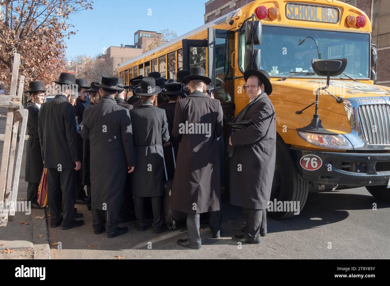 A large group of ultra orthodox Satmar Jewish men from Williamsburg  board a bus to go to a Talmud seminar day in another borough. November  19, 2023. Stock Photo
