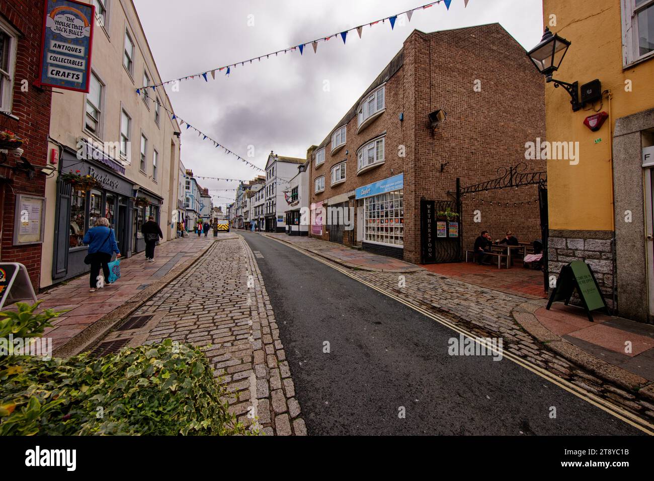 People walk along Southside Street in Plymouth Barbican, Devon, England. Stock Photo