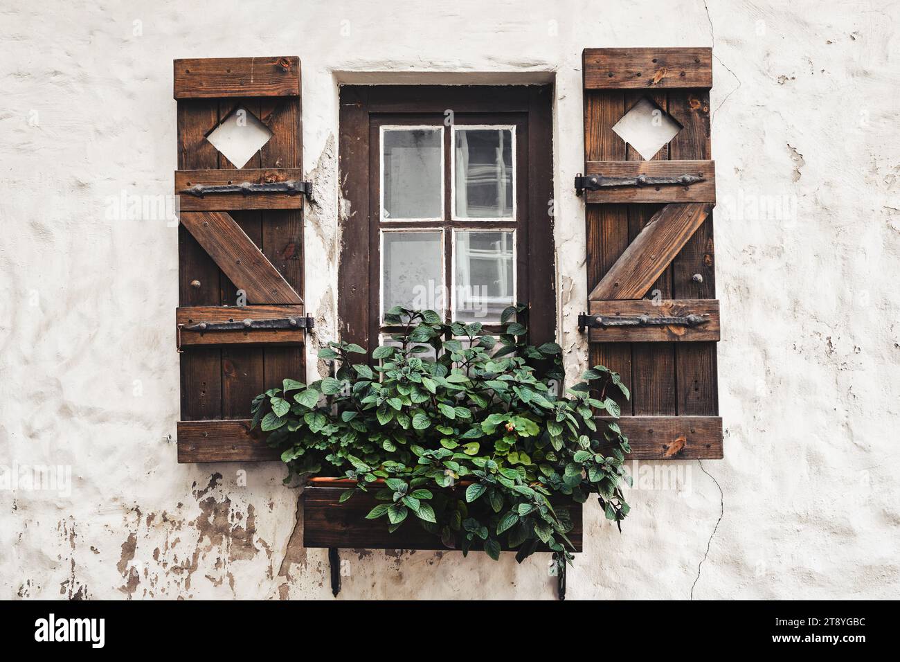 Vintage window with antique wooden shutters decorated with flowers ...