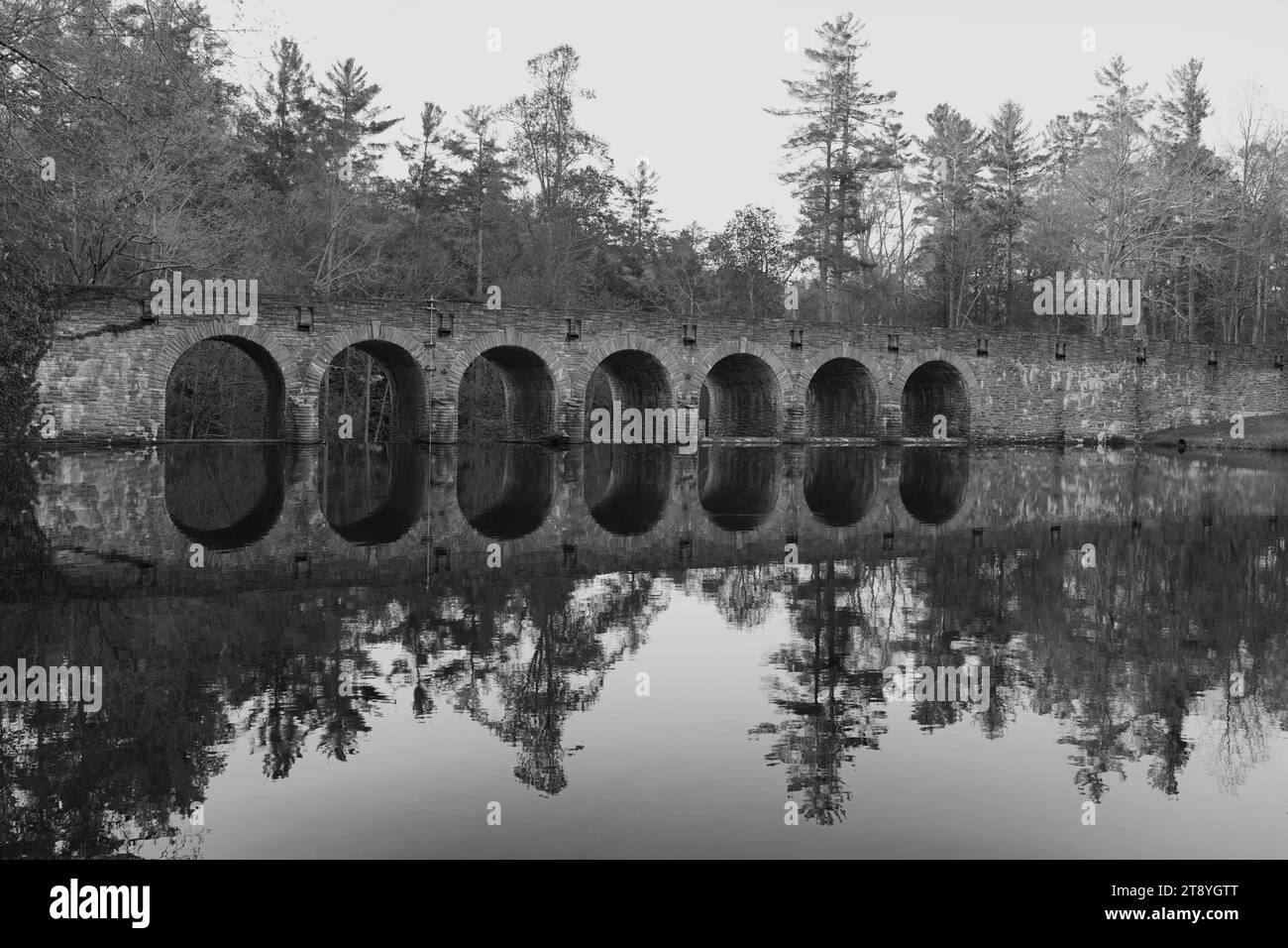 Historic Byrd Lake bridge in black and white reflecting in lake in Cumberland Mountain State