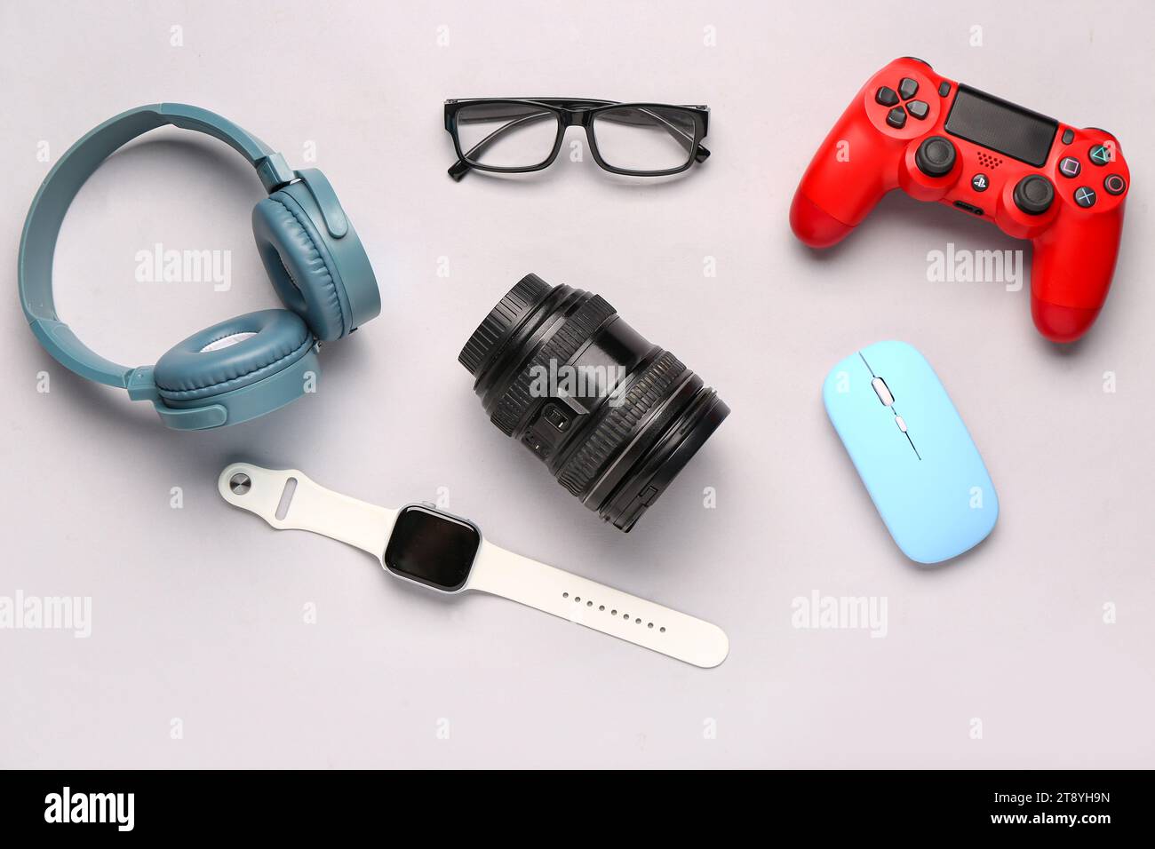 Modern gadgets with eyeglasses on light background Stock Photo