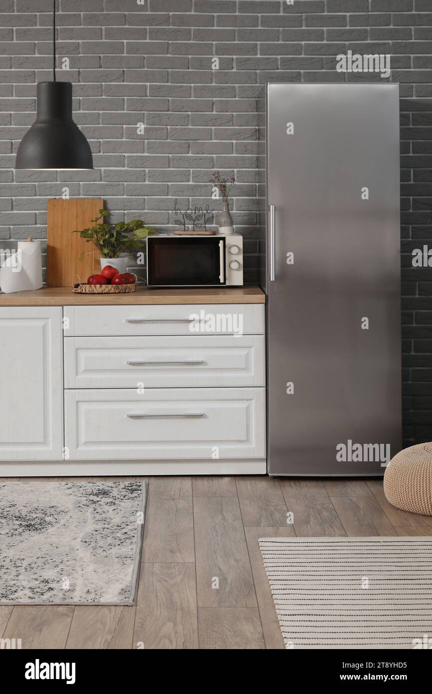 Interior of modern kitchen with white counters and fridge Stock Photo ...