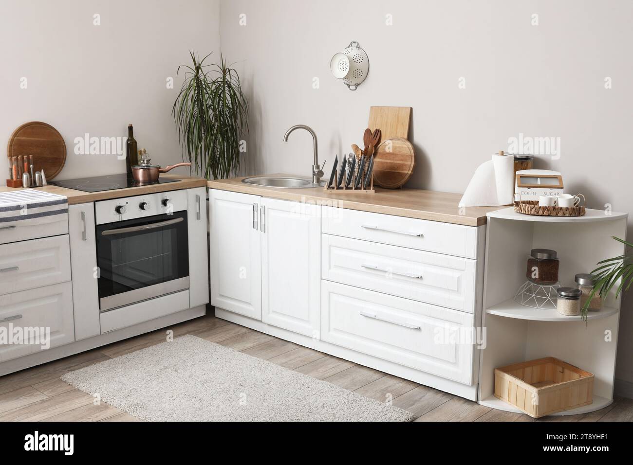 Interior of modern kitchen with white counters, oven and sink Stock ...