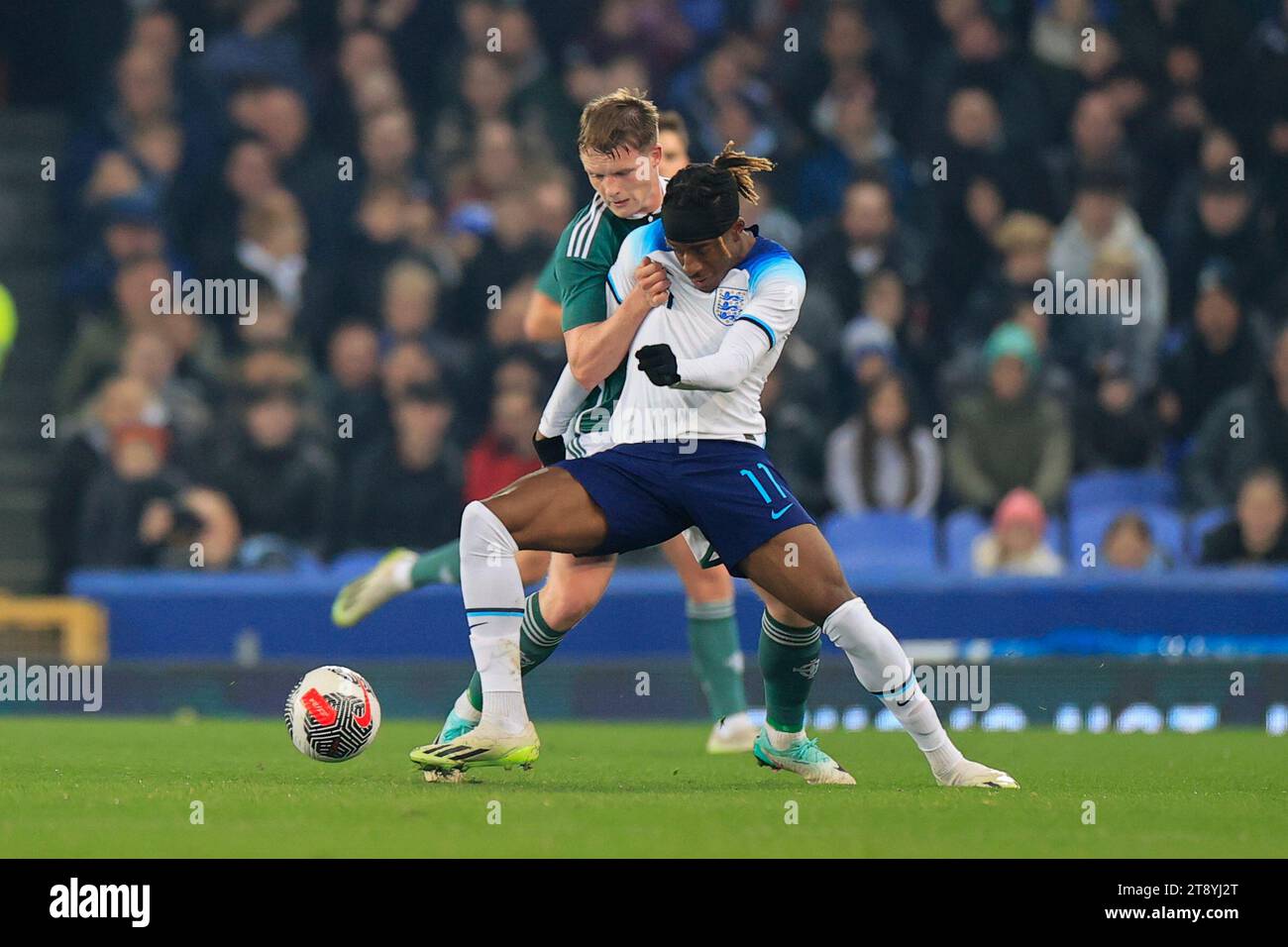 Noni Madueke #11 of England U21 is challenged by Terry Devlin #17  of Northern Ireland U21 during the UEFA Euro U21 Qualifiers match England U21 vs Northern Ireland U21 at Goodison Park, Liverpool, United Kingdom, 21st November 2023  (Photo by Conor Molloy/News Images) Stock Photo