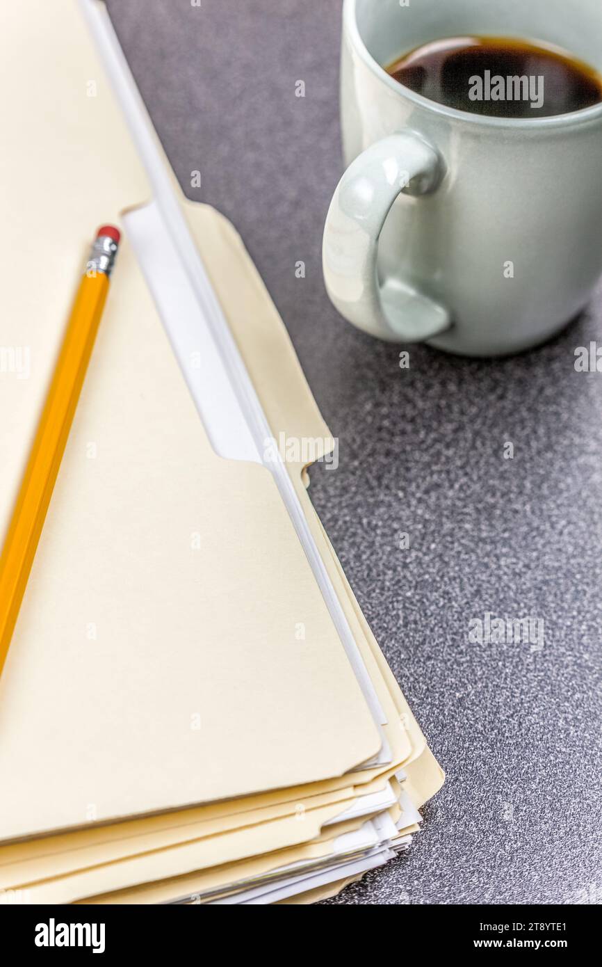 Close-up file folders and coffee on desk in an office Stock Photo