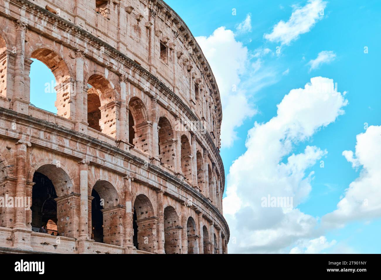 Rome, Italy - November 4 2023: The Colosseum, Architectural wonder of Roman Empire (Colosseo) with blue sky background and clouds Stock Photo