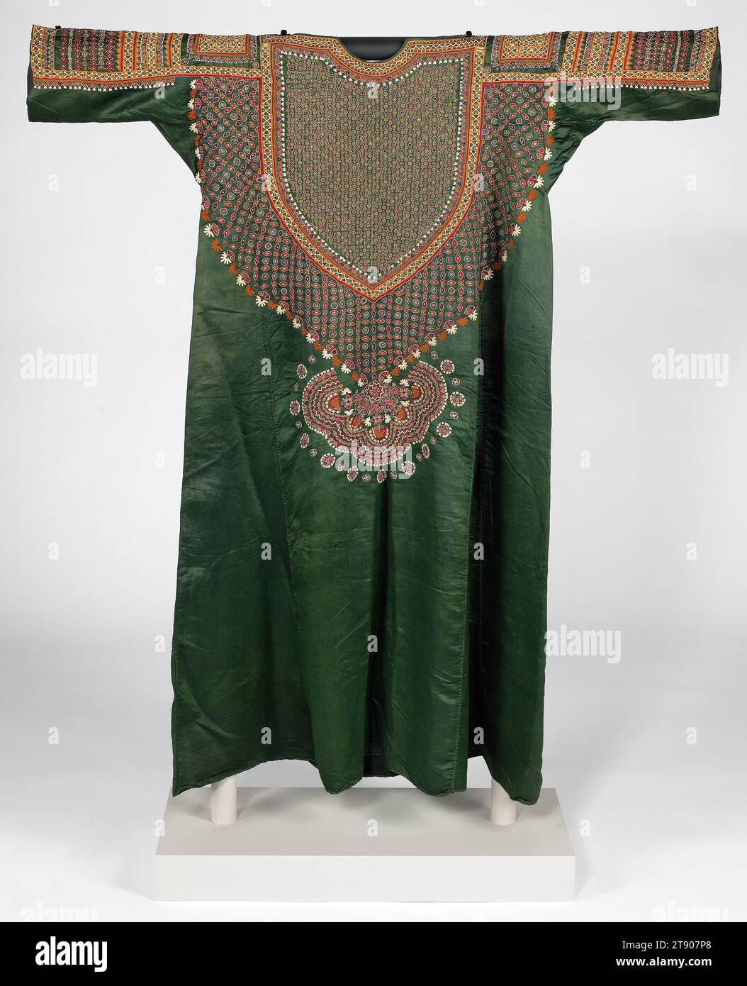 Woman's tunic (Abho), mid 19th century, 47 1/2 x 43 5/16 in. (120.65 x 110.01 cm), Silk, cotton, mirrors; embroidery, India, 19th century, Probably the finest embroidery in all of India came from the Kutch region of Gujarat, where minute stitching and mirror work was a specialty of several Muslim groups. A wealthy Muslim woman would have worn this kind of tunic only on special occasions, completing the ensemble with a coordinating veil and a pair of loosely fitting silk trousers (ejar) with embroidered cuffs Stock Photo