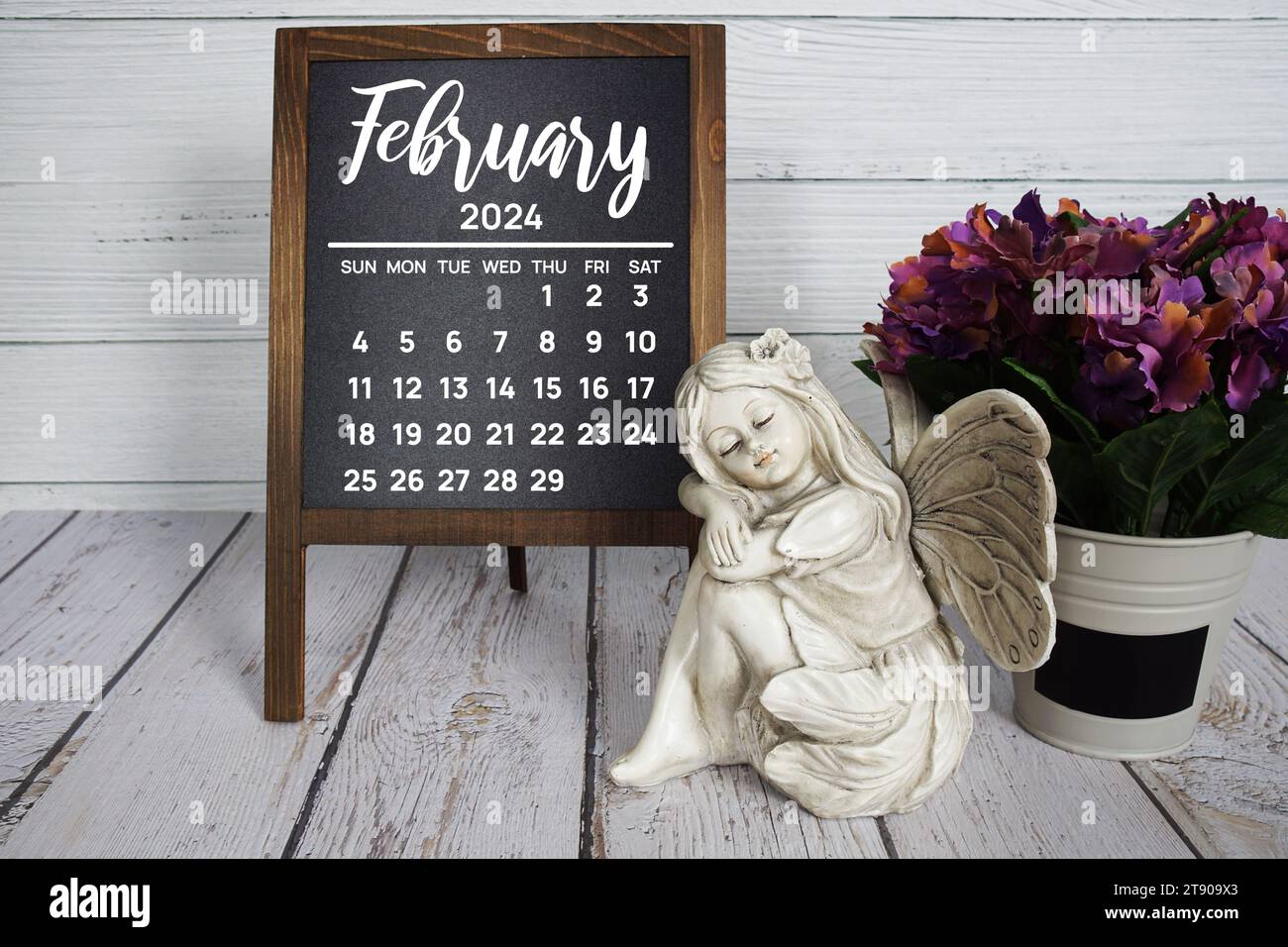 February 2024 monthly calendar with flower bouquet decoration on wooden background Stock Photo