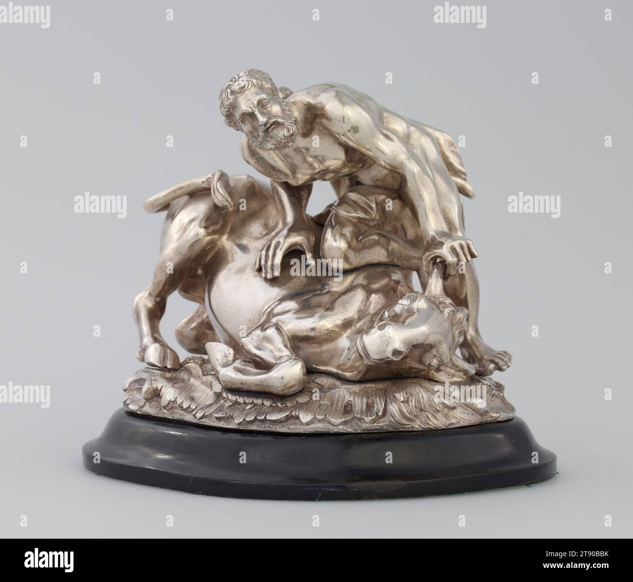 Hercules and the Bull, c. 1820, 5 9/16 x 7 x 5 1/16 in. (14.13 x 17.78 x 12.86 cm), Silver, England, 19th century, This small sculpture of Hercules' seventh Labour, the capturing of the Cretan Bull, was made by an unknown English silversmith in the early 19th century for Prince Augustus Frederick, Duke of Sussex (1773-1843). The only further known cast of this model is kept by Her Majesty the Queen at Buckingham Palace. Originally the silver sculpture would have served as an ornament for the dining table - a particularly appropriate subject whenever beef was served Stock Photo