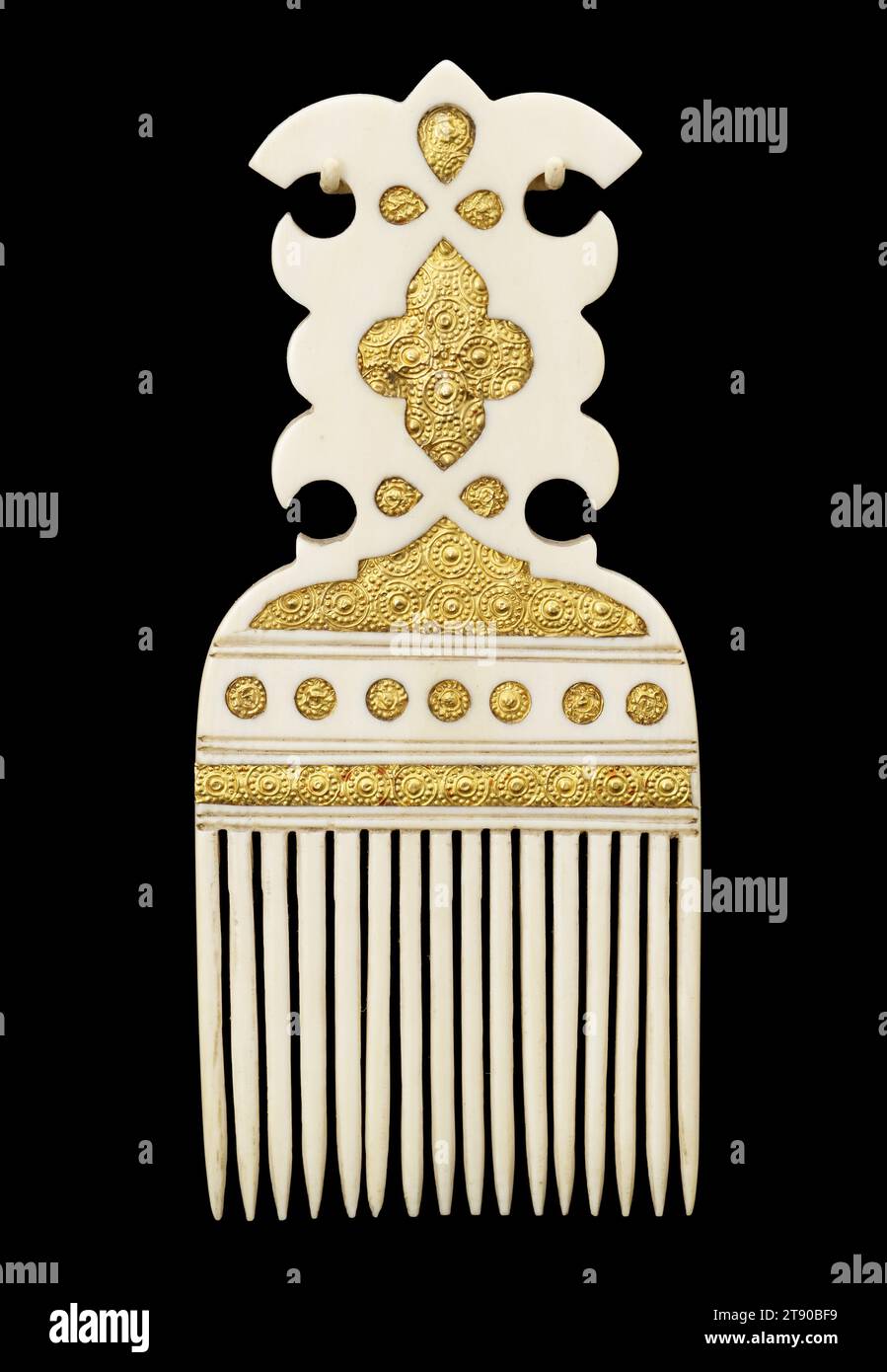 Hair comb, about 1800, 4 15/16 x 2 1/8 x 1/4 in. (12.5 x 5.4 x 0.64 cm), Ivory, gold, Tanzania, 18th-19th century, Whoever gave this comb to his wife more than 200 years ago must have loved her dearly. Carefully carved and made of precious materials (elephant ivory and gold folio), it’s something the owner would have shown off, perhaps even wearing it in her hair. It would signal that she was among the wealthy elite of Zanzibar, and had married well Stock Photo