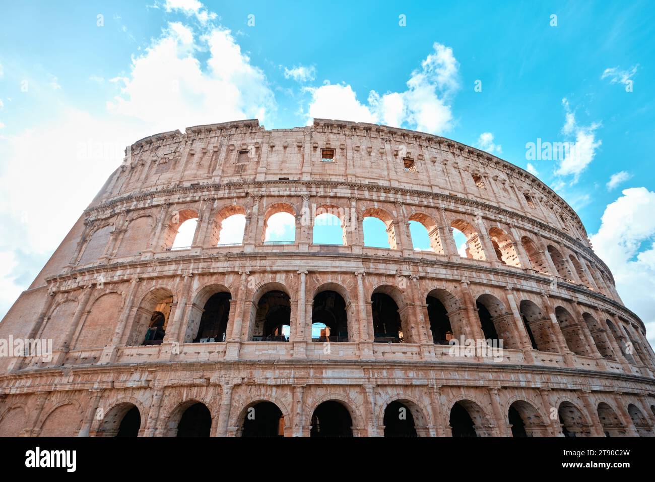 Rome, Italy - November 4 2023: The Colosseum, Architectural wonder of Roman Empire (Colosseo) with blue sky background and clouds Stock Photo