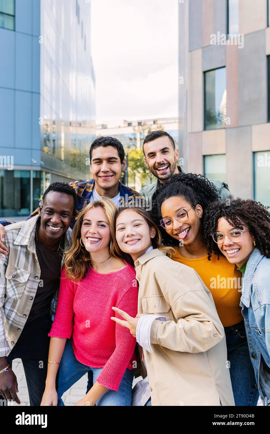 Vertical portrait of young group of diverse people smiling at camera ...