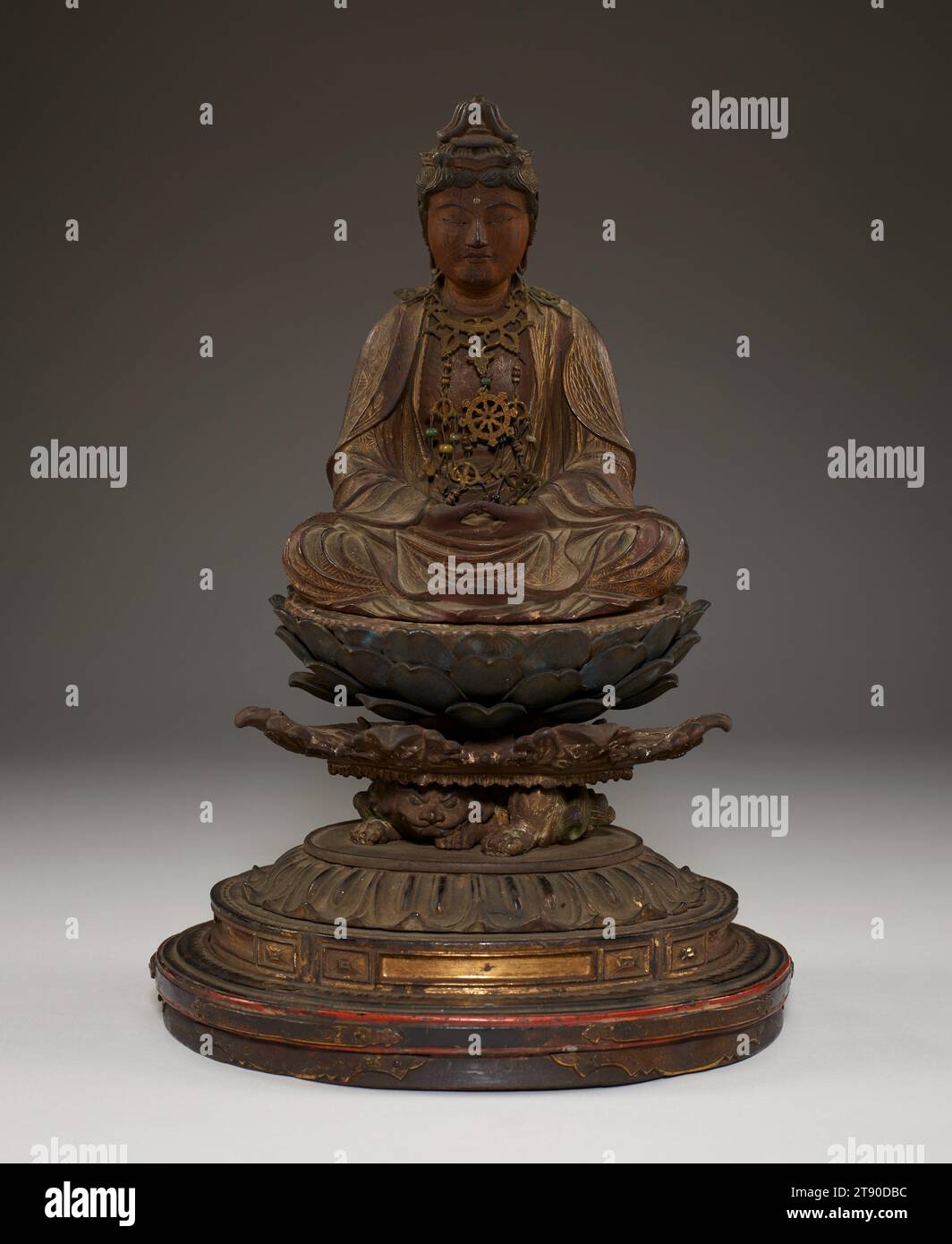 Miroku, the Bodhisattva of the Future, second half 13th century, Unknown Japanese, 11 1/2 × 7 1/2 × 6 5/8 in. (29.21 × 19.05 × 16.83 cm), Wood with metal, cut gold leaf (kirikane), polychrome, and inlaid crystal eyes, Japan, 13th century, Miroku Bosatsu is seated on a lotus throne perched on a struggling demon, holding a pagoda in his upturned palms. The statue retains its original metal raiments, as well as the gold leaf decoration on the draped robes. The figure’s princely attire indicates that Miroku is being depicted in his incarnation as a bodhisattva, an enlightened being Stock Photo