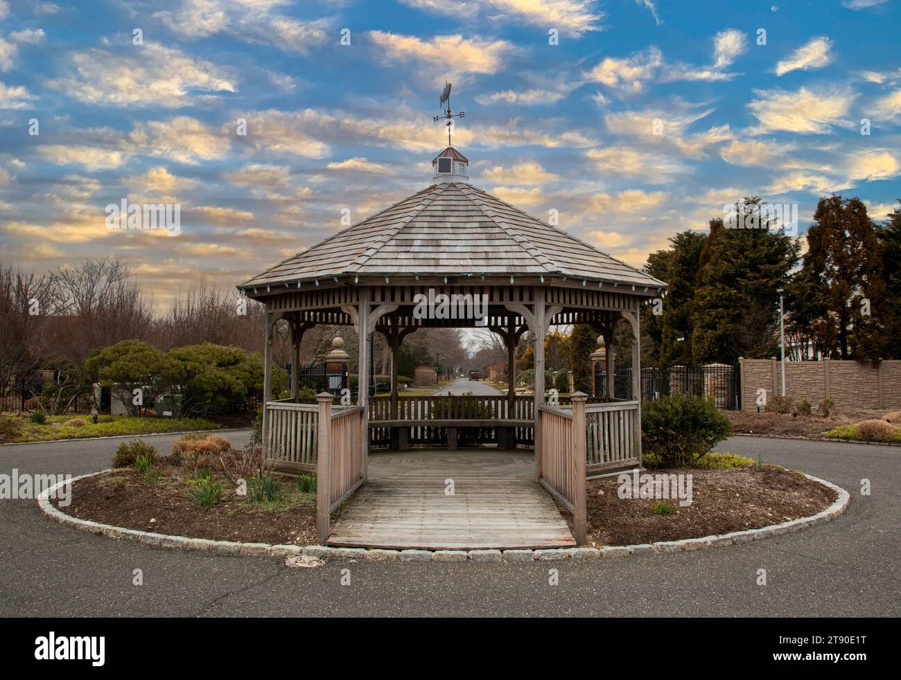 A wooden gazebo sitting in the middle of a park. Stock Photo