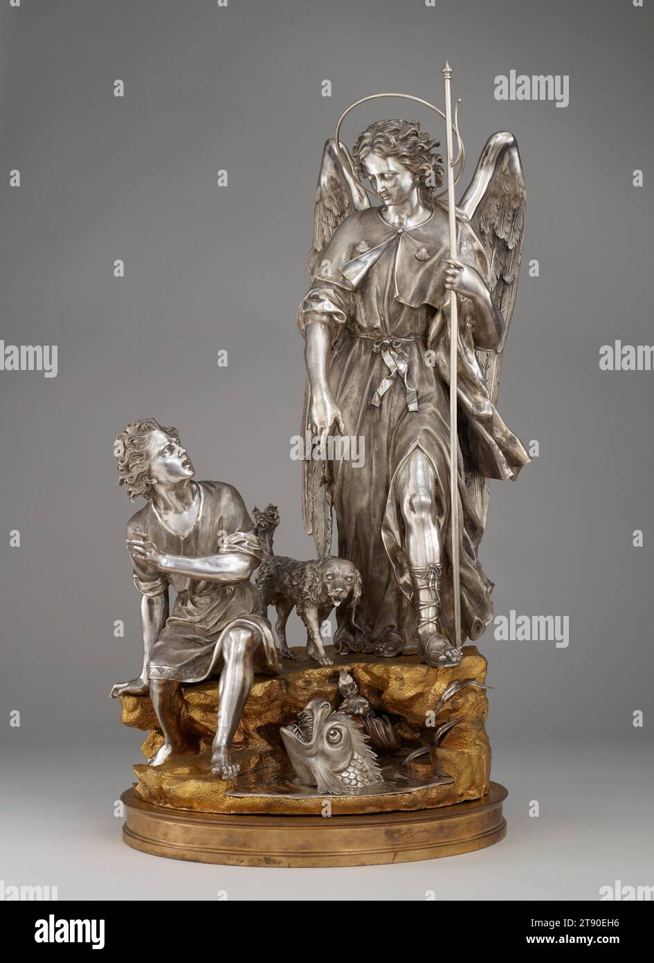 Saint Raphael with Tobias, His Dog, and the Fish, c. 1780, Giuseppe Sanmartino, Italian, 1720–1793, 27 1/4 × 17 1/4 × 12 1/2 in. (69.22 × 43.82 × 31.75 cm), Silver, gilt bronze, Italy, 18th century, Tobias, a young Jewish man, has been sent by his blind father to retrieve money left with a relative. Accompanying him on the journey are his dog and a hired guide who, unbeknownst to him, is the archangel Raphael. When they reach the Tigris River, Tobias is attacked by a monstrous fish. Raphael tells him to catch it and preserve its innards as medicines. Stock Photo