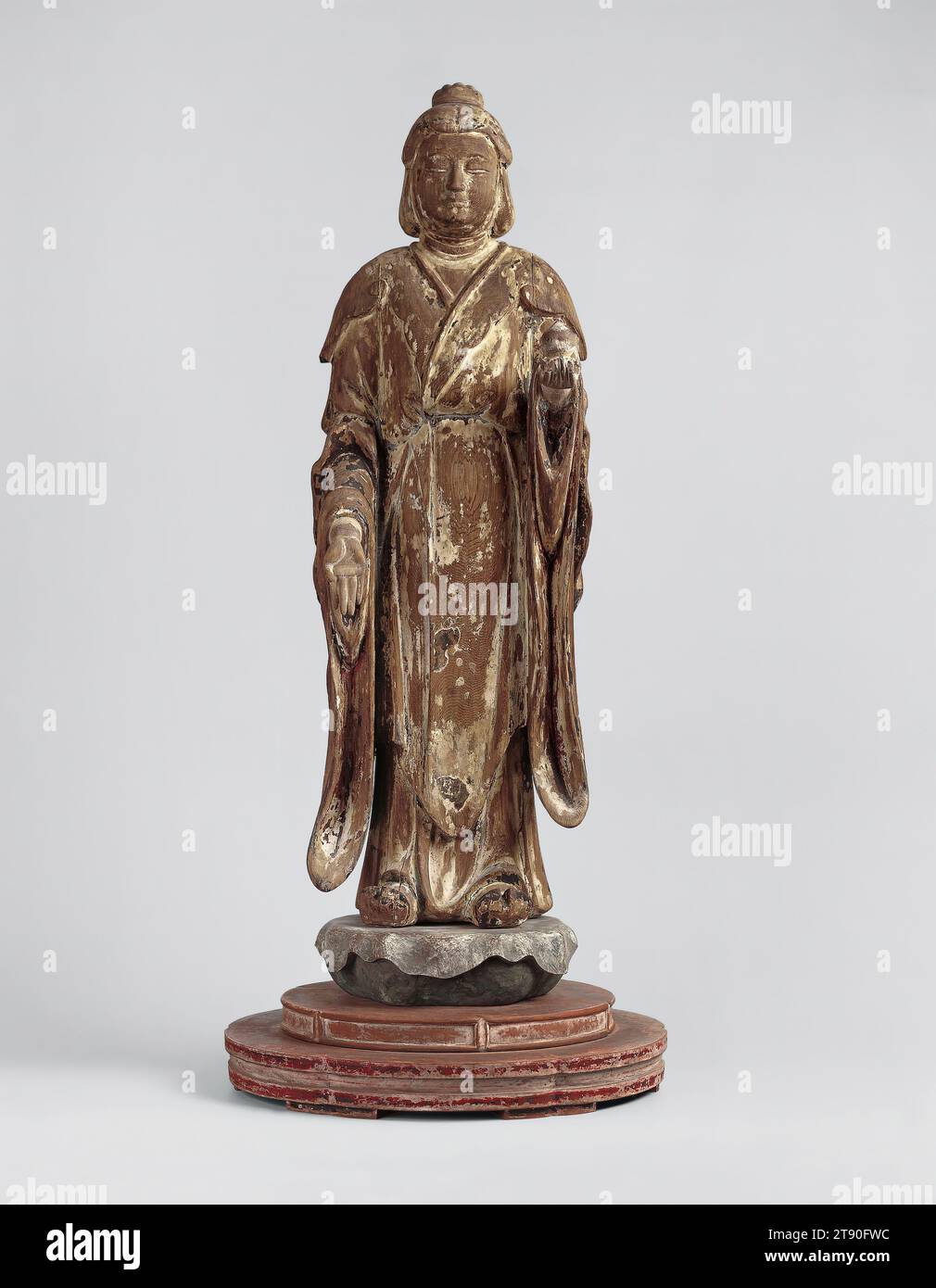 Shri-mahadevi (Kichijōten), first half 14th century, Unknown Japanese, 33 1/4 × 13 3/8 × 13 1/2 in. (84.46 × 33.97 × 34.29 cm) (with base), Lacquered and polychromed Japanese cypress, Japan, 14th century, Shri-mahadevi is a female Buddhist divinity with Hindu origins. In Hinduism, she is Lakshmi, a goddess associated with good fortune and the wife of Vishnu, one of Hinduism’s three principal gods. Chinese Buddhists, however, transformed her into a deva, a supernatural being that has extreme longevity but remains outside the realm of enlightenment and attempts to assist believers Stock Photo