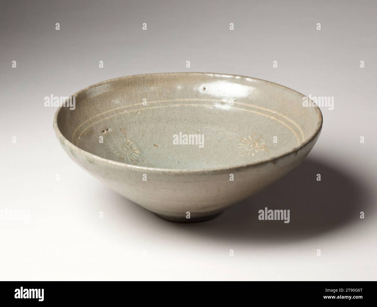 Bowl with chrysanthemum design, late 14th century, Unknown Korean, 2 7/8 × 7 5/8 × 7 1/2 in. (7.3 × 19.37 × 19.05 cm), Stoneware with stamped and inlaid design under celadon glaze, Korea, 14th century Stock Photo