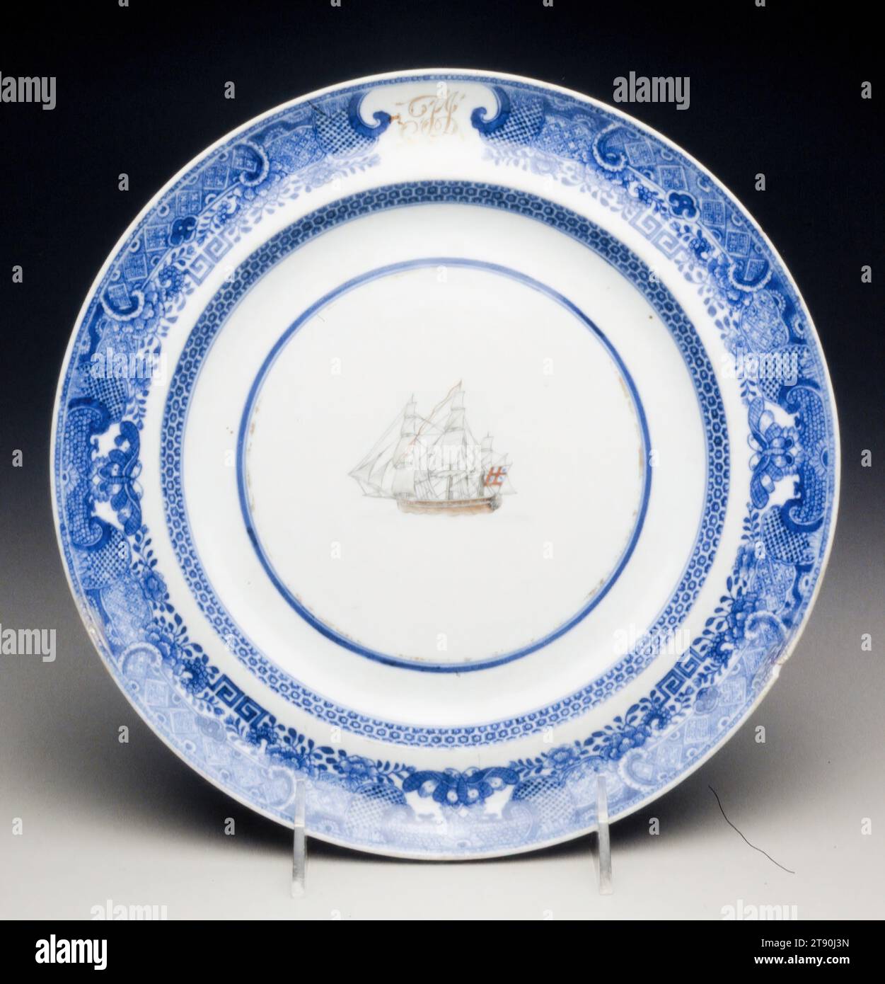 Plate with the initials 'T.J.' and sailing scene, c. 1800, 15/16 x 9 7/8 in. (2.38 x 25.08 cm), Porcelain, China, 18th-19th century, The central image on this plate shows a British East Indiaman of about 1800. The initials in the space left free in the rim design indicate that this was a popular generic underglaze blue design from Jingdezhen, to which any initials as well as vessel could be added in Canton Stock Photo