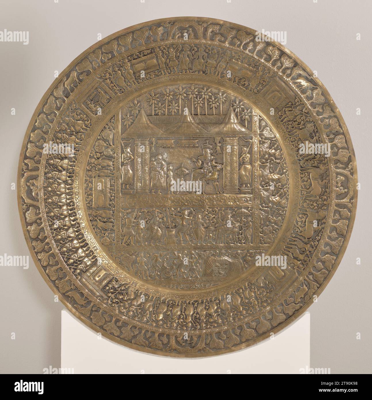 Commemorative dish depicting the fall of the Kingdom of Kandy, c. 1815, 3/4 × 24 × 24 in. (1.91 × 60.96 × 60.96 cm), Brass, Sri Lanka, 19th century, The vivid scenes hammered into the surface of this large brass dish commemorate the epic fall of the Kingdom of Kandy (1592–1815), the last independent state in Sri Lanka (Ceylon) to succumb to British Crown rule. The design echoes that of Kandyan mural painting, with events staged in a series of illustrated panels, accompanied by brief descriptions incised in the local language (Sinhalese). Stock Photo